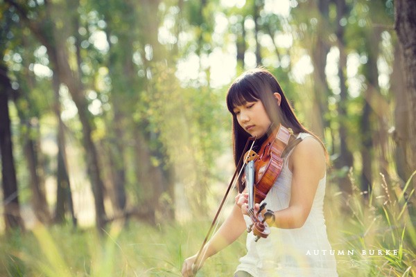 colorado high school senior portrait girl in field playing instrument violin